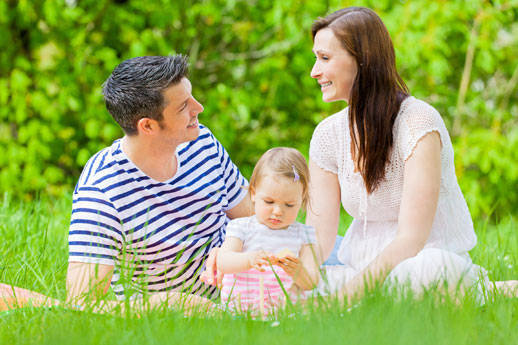 family relaxingtogether on picnic blanket